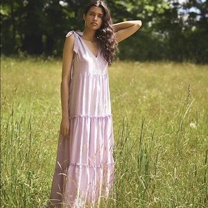 A sweetly tiered silhouette and a hint of shimmer make this dress a favorite